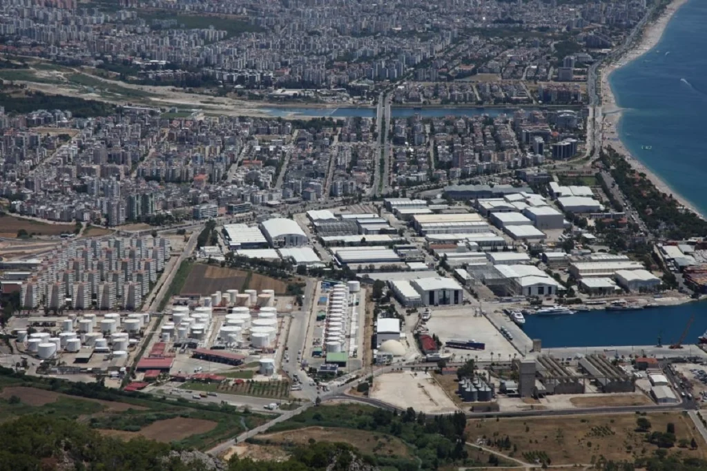 Aerial view of Antalya Free Zone showing industrial facilities, port infrastructure, and surrounding urban development along the Mediterranean coast of Turkey, ideal for foreign investors and export-oriented businesses.