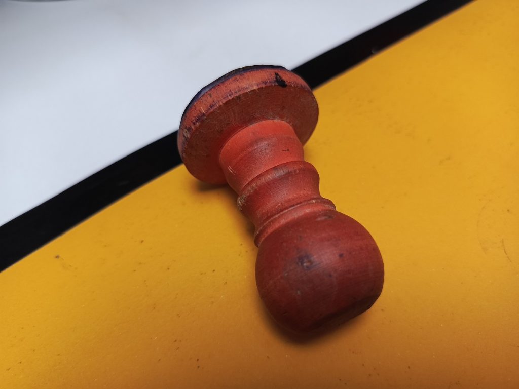 Close-up photo of a red wooden stamp used for verifying foreign id number in turkey