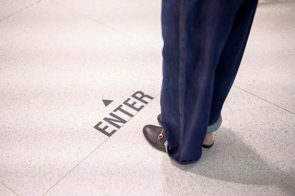 Person standing on the floor near an arrow pointing to the "Enter" key symbolizing the concept of re-entry after lifting turkey visa overstay ban.