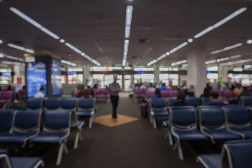Blurred airport waiting area representing travelers facing Turkey Overstay Fine outcomes and entry delays in 2025