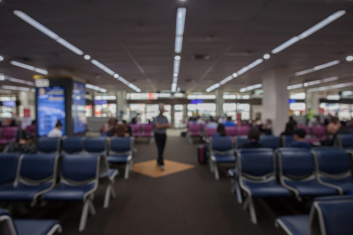 Blurred airport waiting area representing travelers facing Turkey Overstay Fine outcomes and entry delays