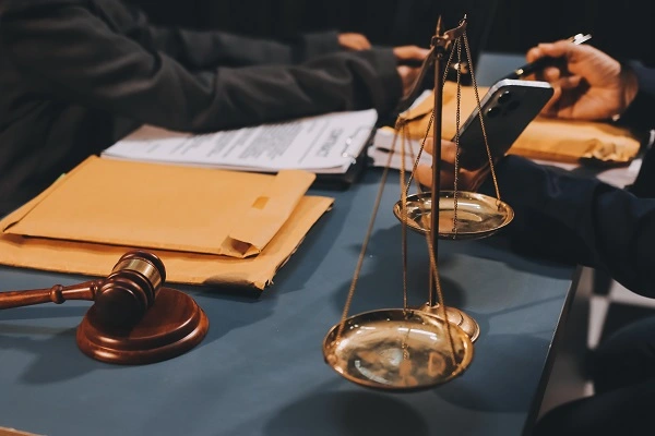 Avukat ile yapılan görüşmede adalet terazisi ve dava evrakları, Uzaklaştırma Kararı Nasıl Alınır sürecinde hukuki destek ihtiyacını gösteriyor.